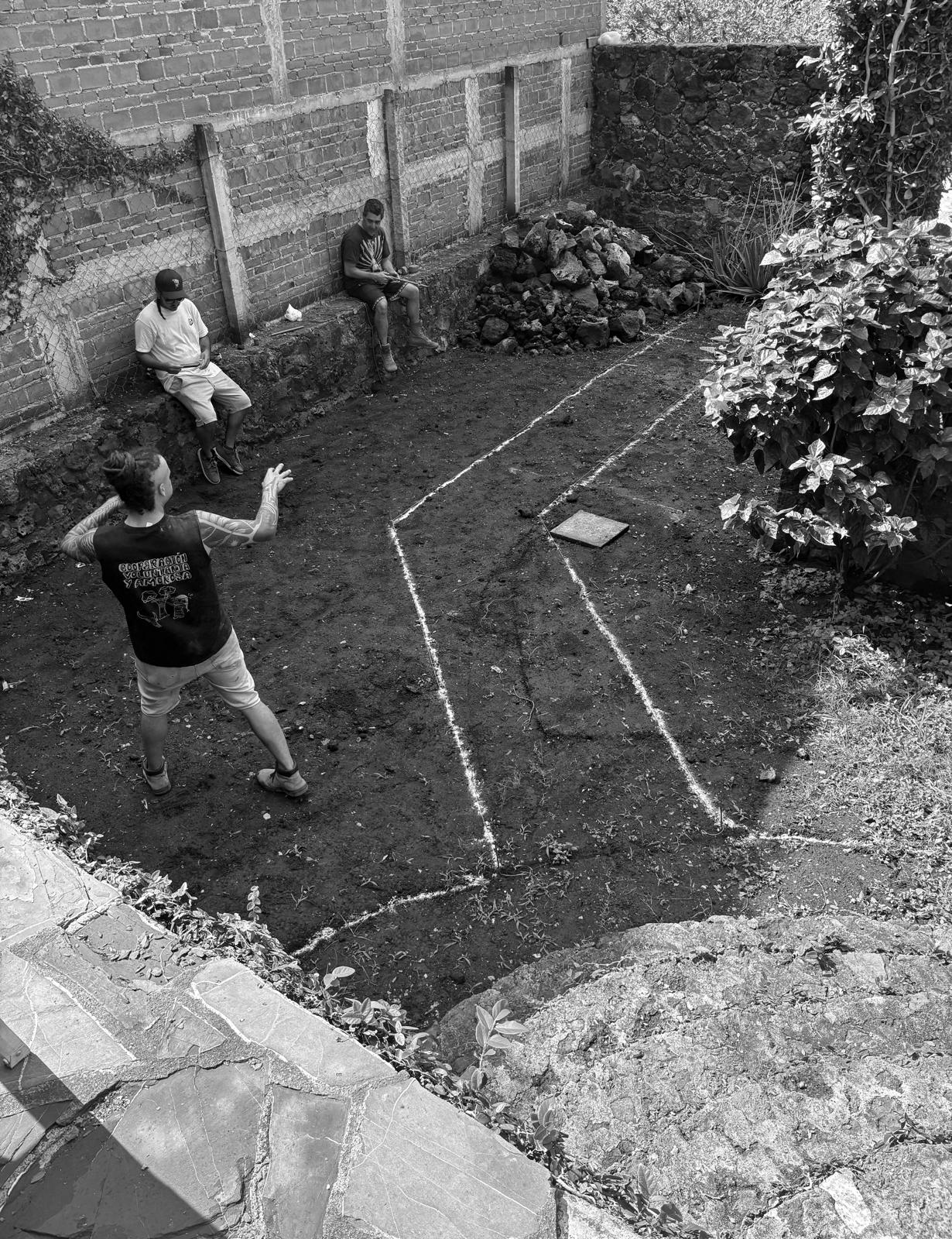 Team marking out chalk lines across an excavated site
